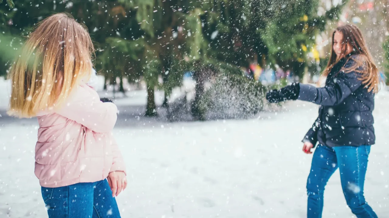 young girl on a winter day in the forest throws