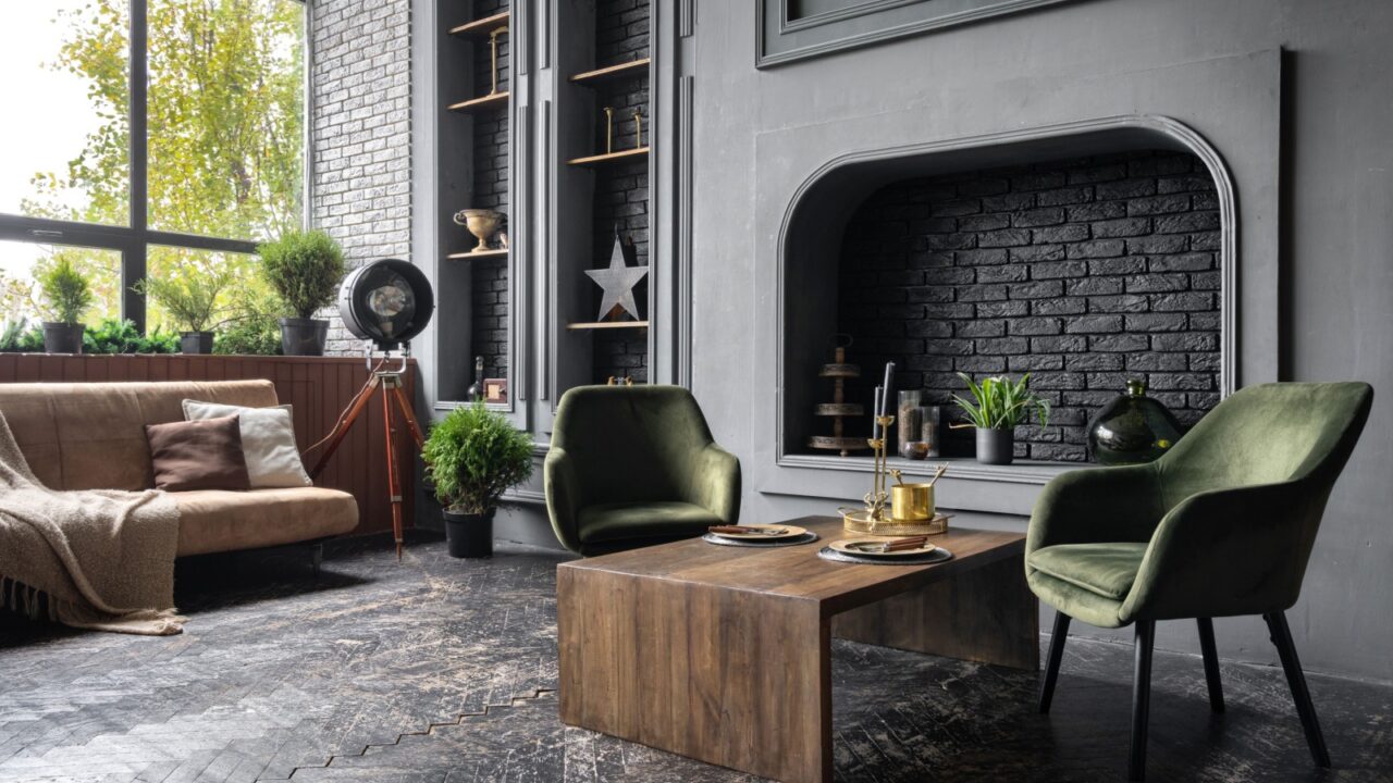 A modern living room interior with green accent chairs, wooden coffee table, brown sofa, and potted plants.