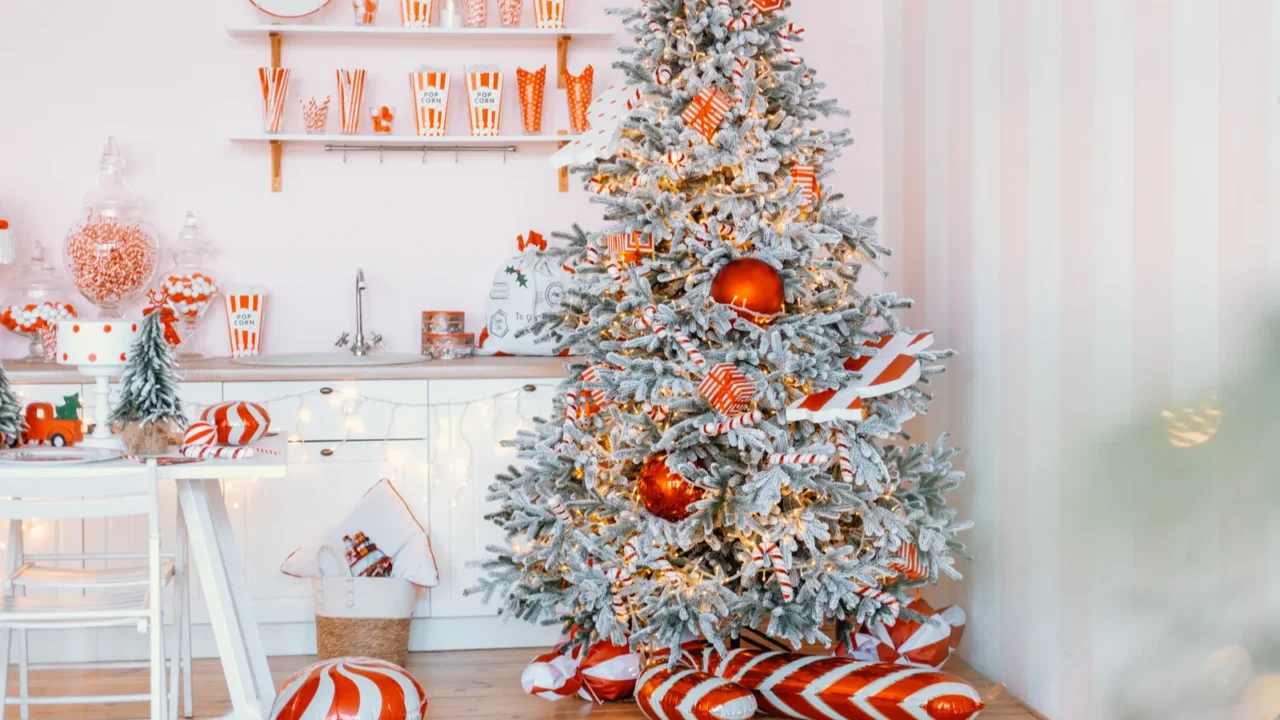 a beautifully decorated christmas tree fills the corner of a