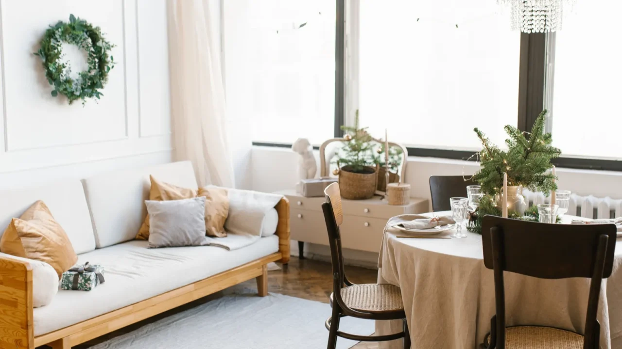 a dining table with wooden chairs decorated and served for