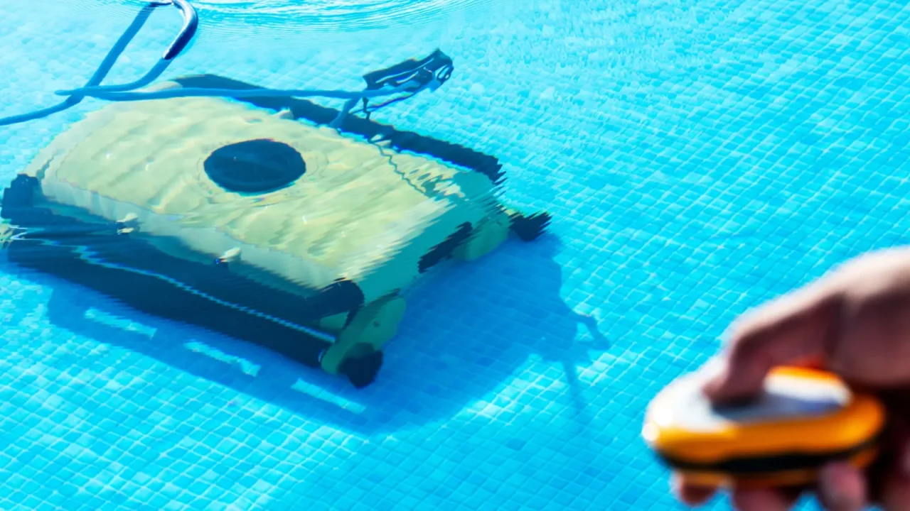 a robotic pool cleaner works efficiently in a clear blue