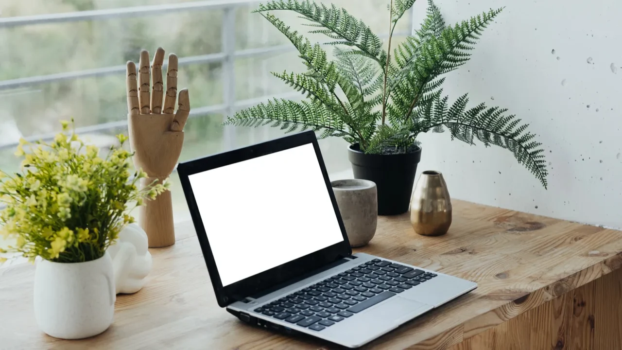 a serene workspace features a small laptop on a wooden