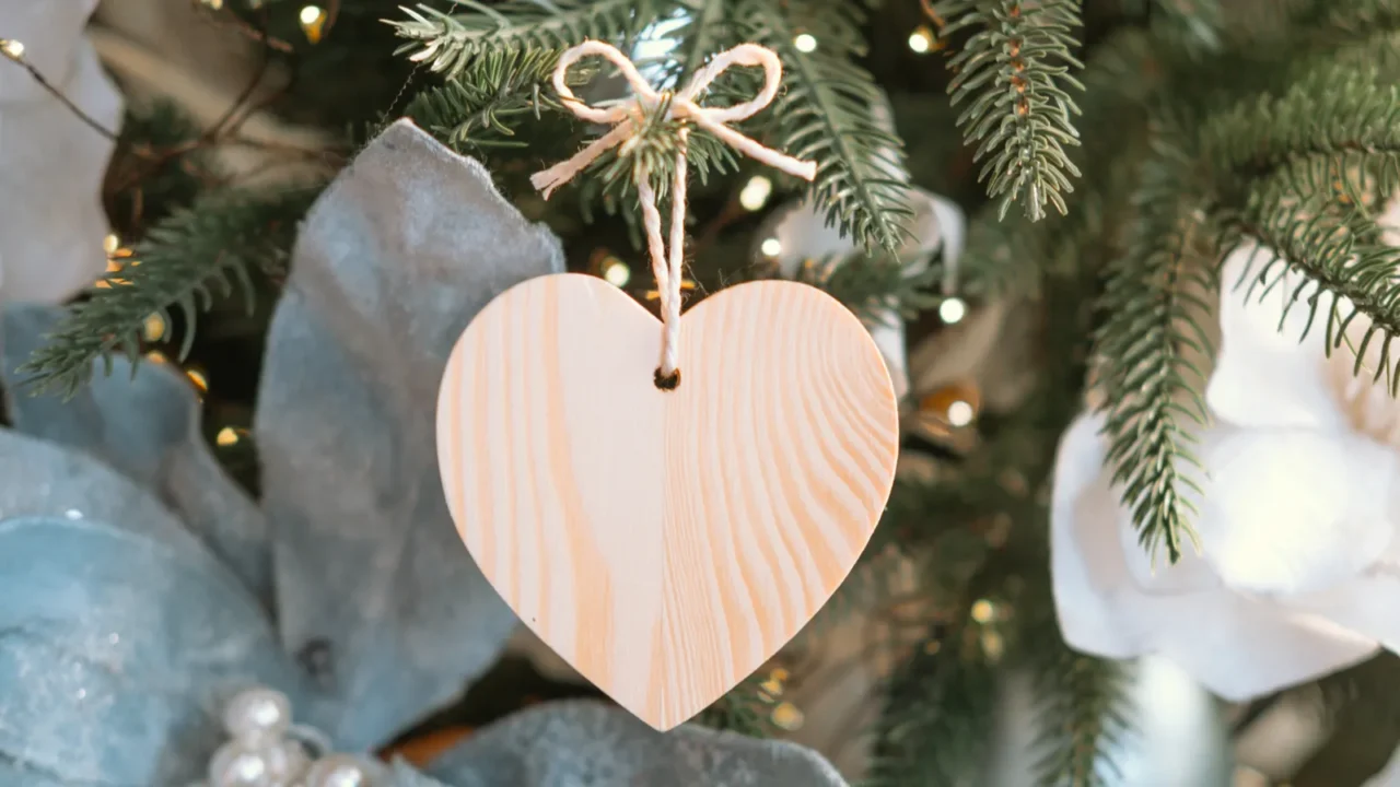 a wooden heart ornament is gracefully hung on a christmas