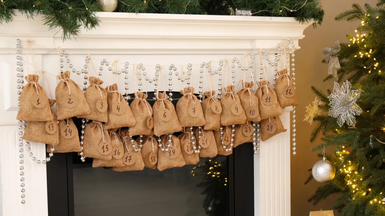 advent calendar with gifts and decor hanging on fireplace christmas