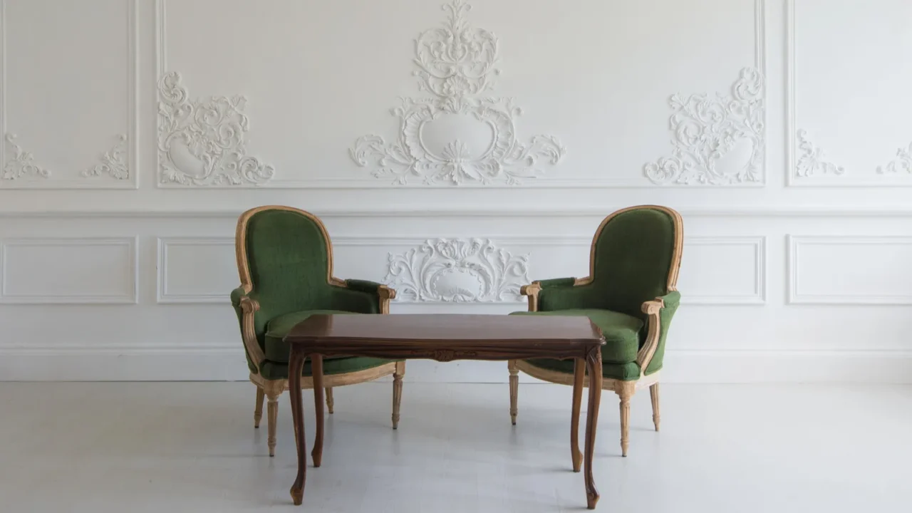 Apartment interior classic vintage style furniture set. White molding wall. A pair of olive green sofas with a dark brown table.