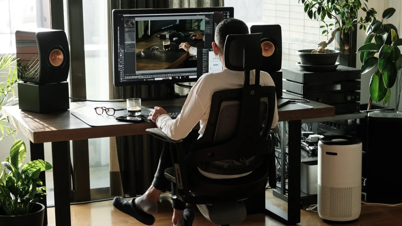 back view of middle aged man working on his computer