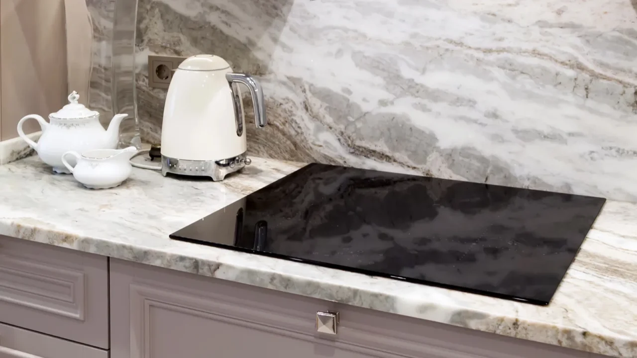 beautiful closeup of custom designed kitchen with marble looking quartz