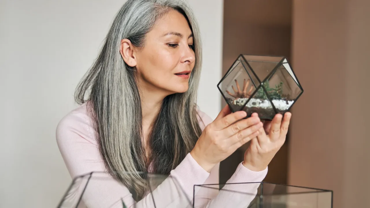 beautiful woman holding geometric glass succulent florarium