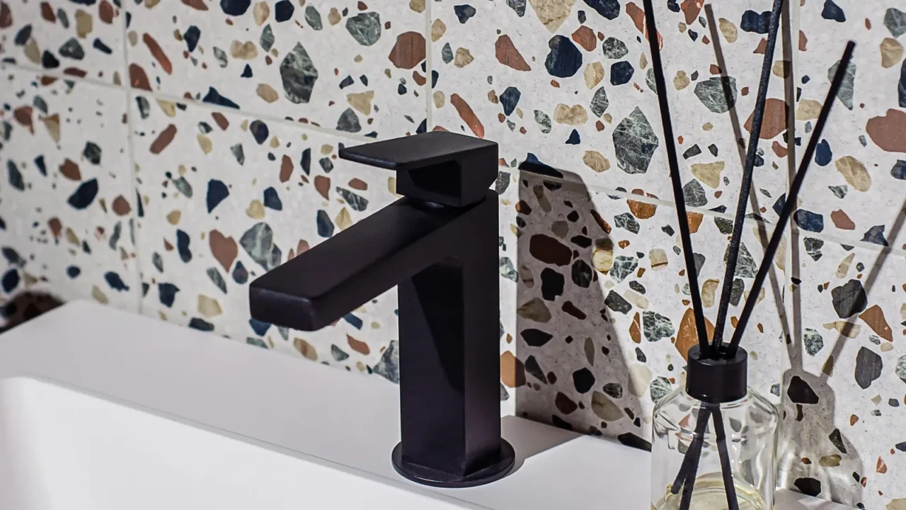 black faucet on the washbasin in the bathroom the wall