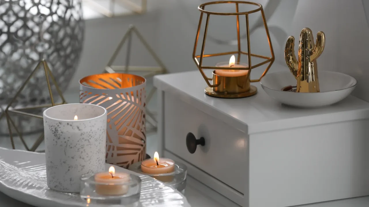 burning candles in beautiful holders on table indoors