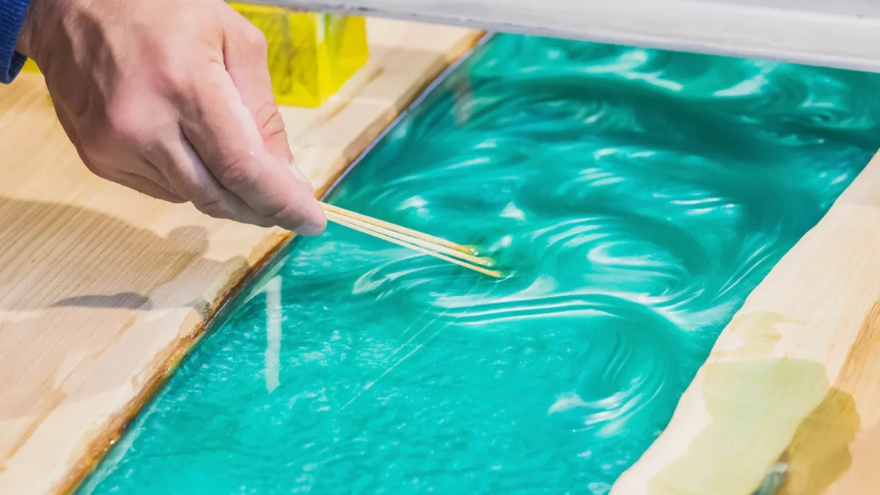 carpenter mixes epoxy to create a tracery on the kitchen