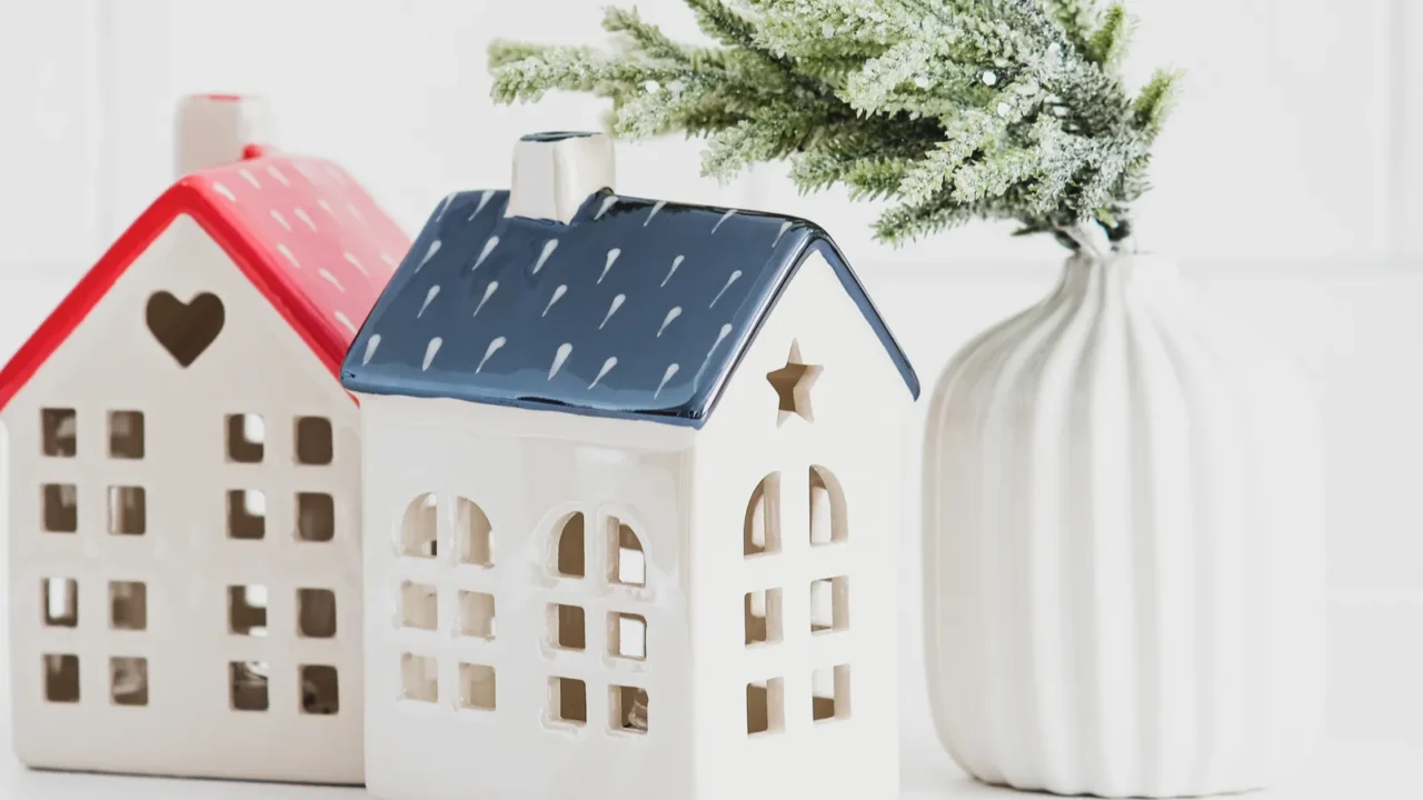 christmas home decor on white table two little ceramic houses