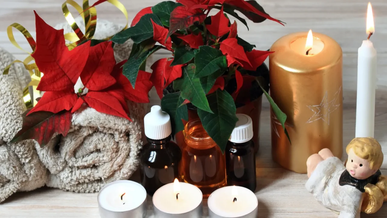 christmas spa concept with candles and red christmas flower poinsettia