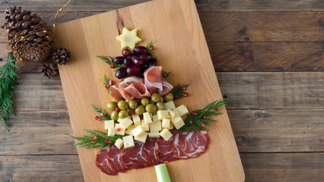 christmas treeshaped cheese and charcuterie appetizer board with wooden base