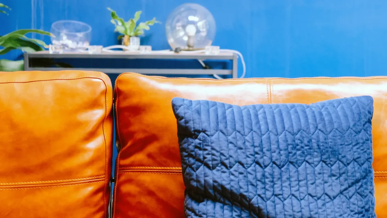 close up detail of blue pillow on leather sofa