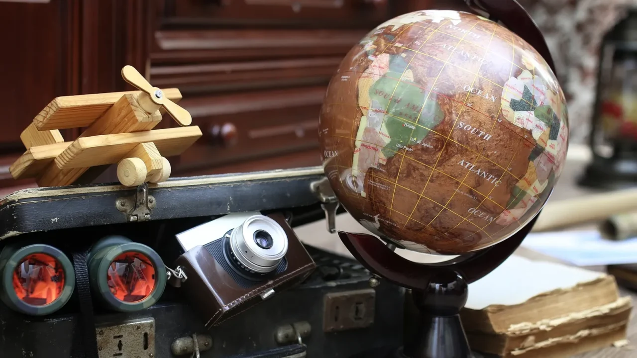 composition on a wooden floor vintage globe with old leather