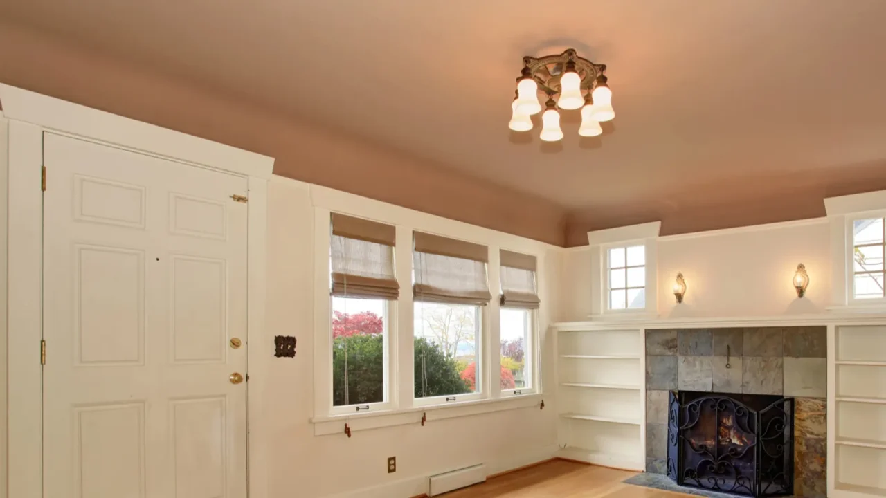 Cozy living room with rose interior ceiling paint. Big white windows and a well-lit room.