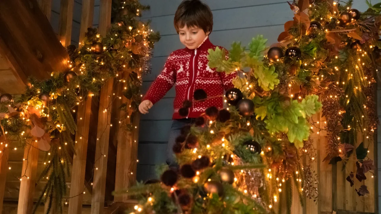 cute little kid run down decorated stairs