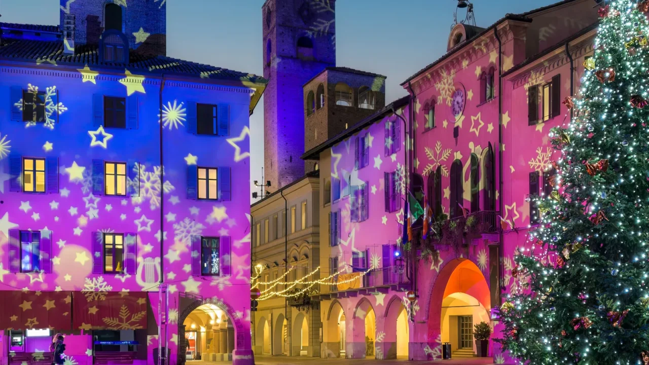 Evening view of the a festive town square decorated for holidays.