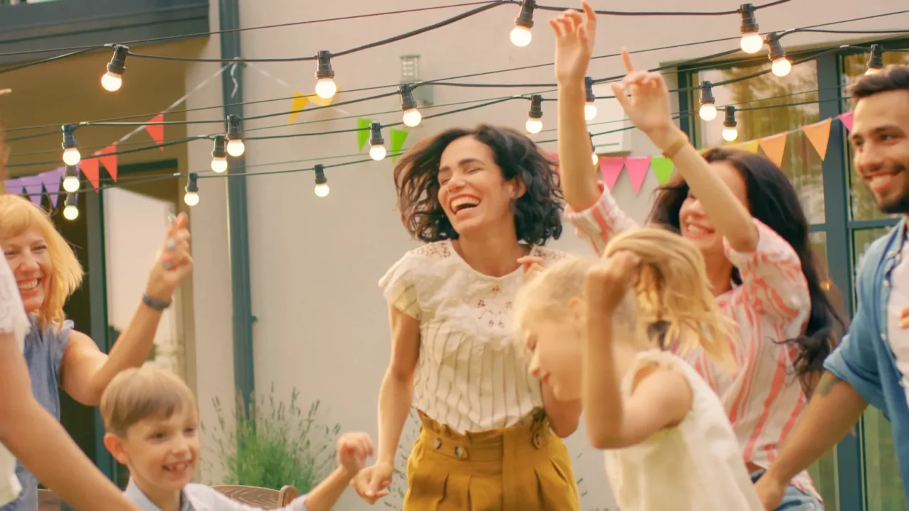 family and friends dancing together at the garden party celebration