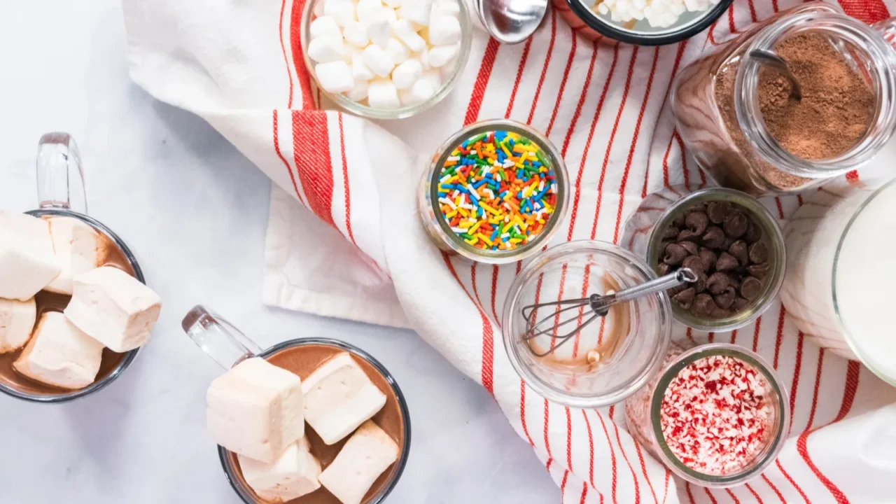 flat lay hot chocolate bar with variety of topping on