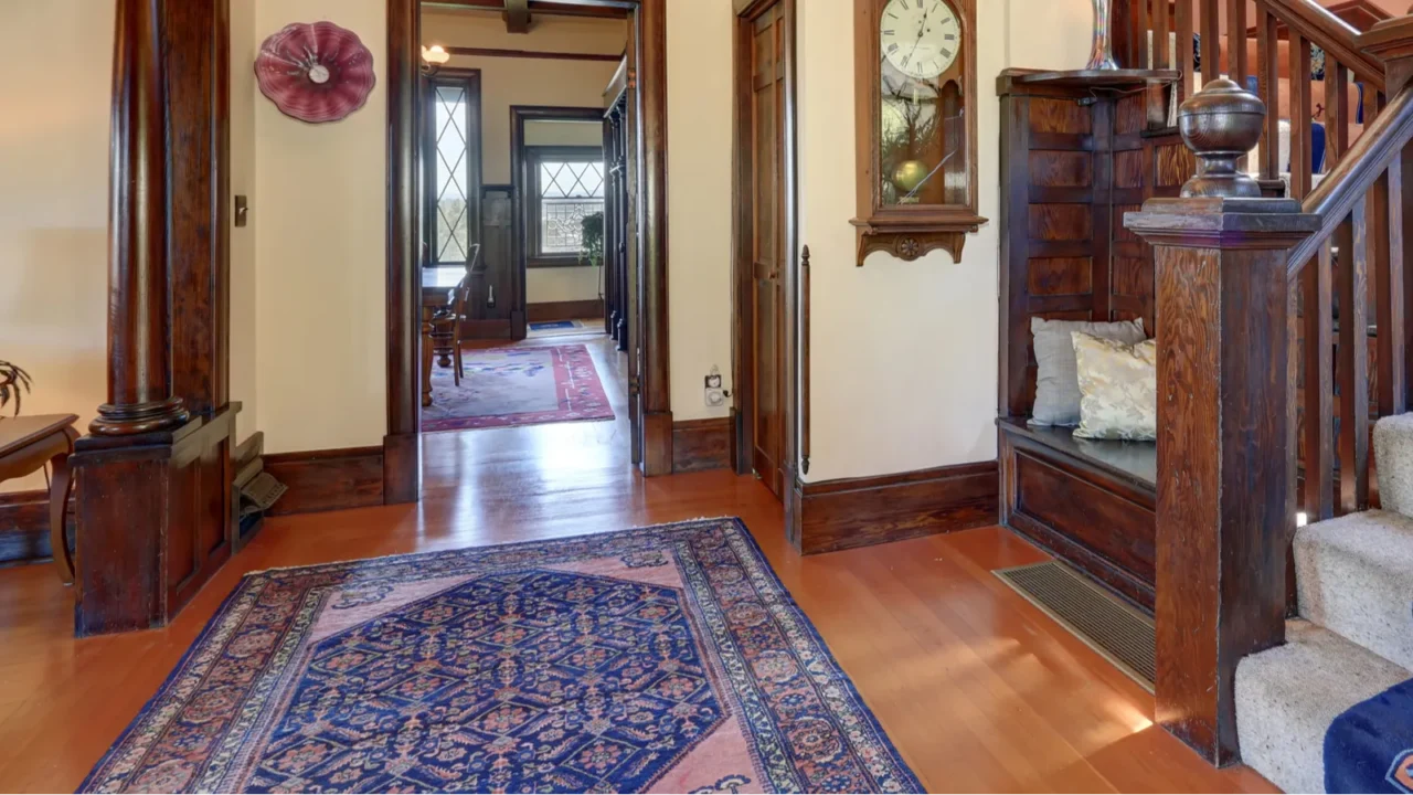 hallway with brown trim and hardwood floor in old house