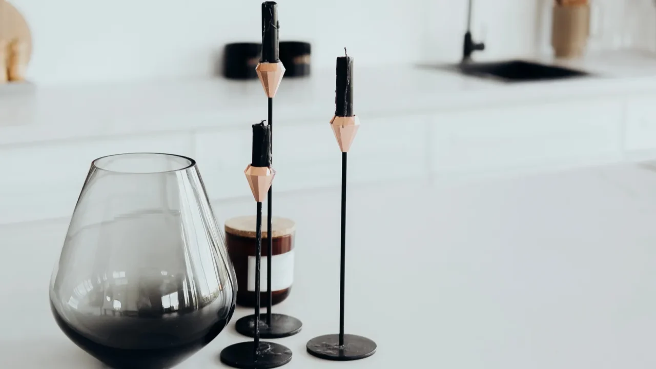 in a contemporary kitchen three stylish candlesticks with candles stand