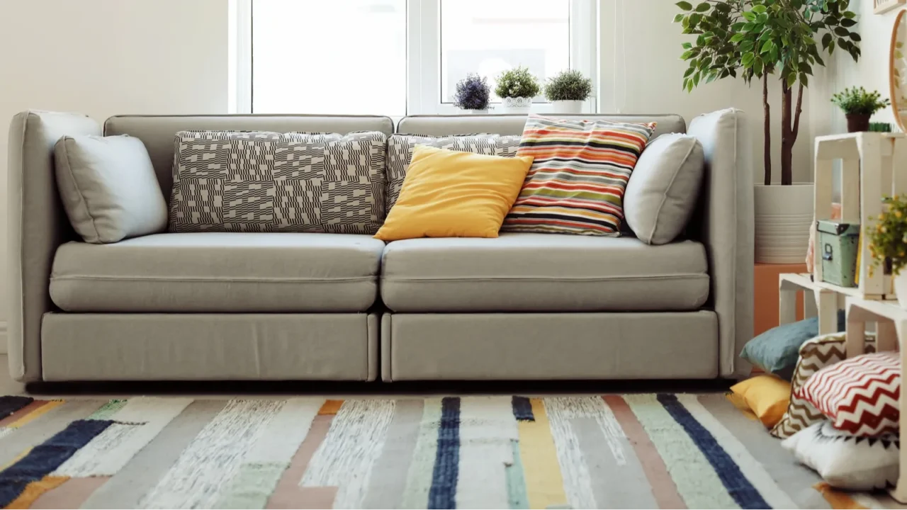 interior of modern living room with pillows on sofa