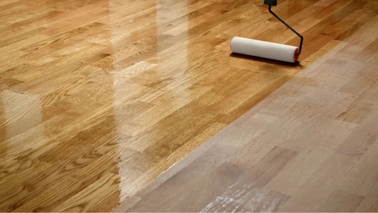 lacquering wood floors worker uses a roller to coating floors