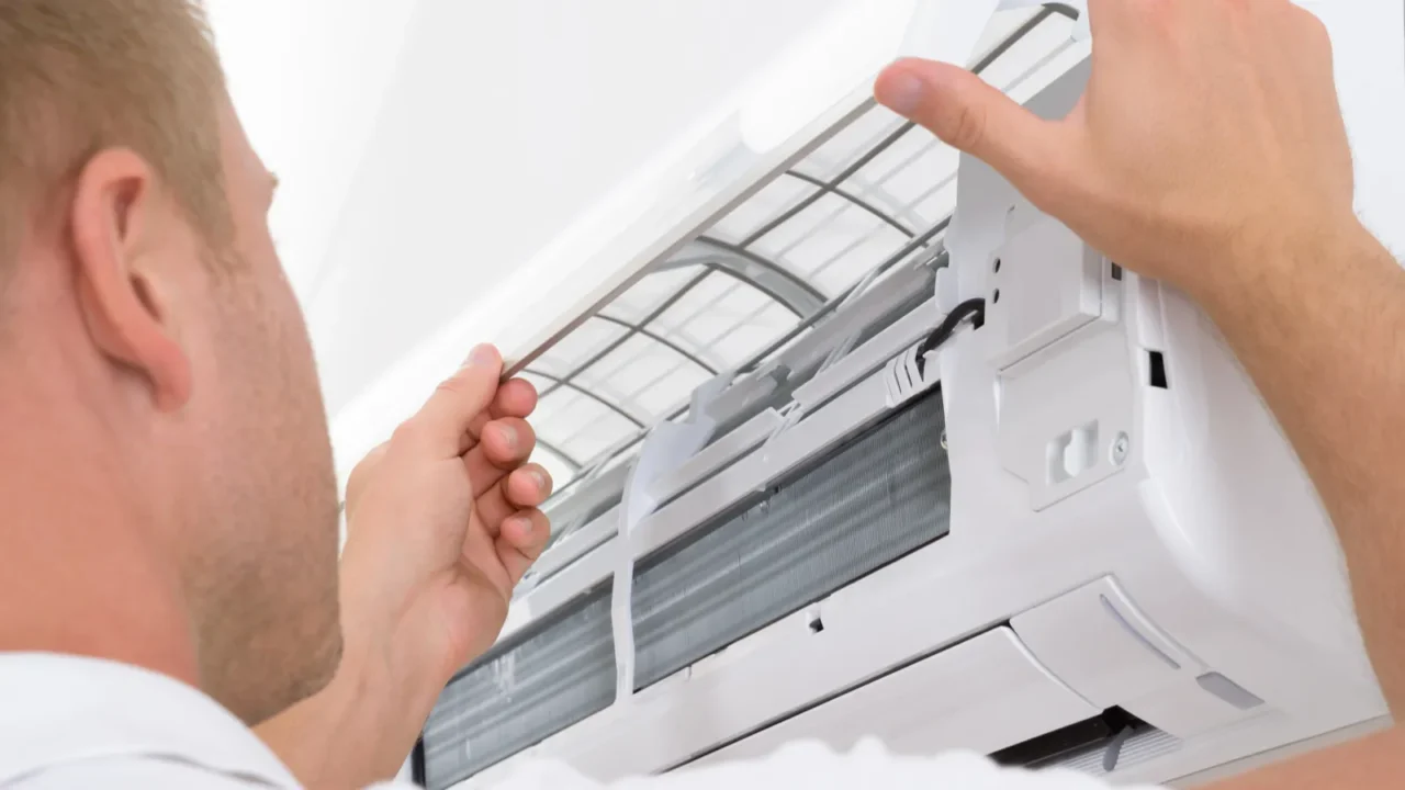 man adjusting air conditioning system