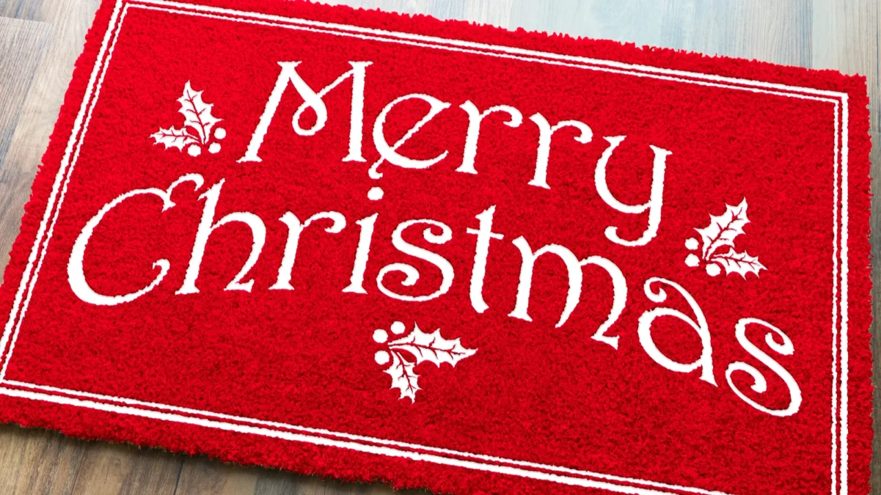 merry christmas red welcome mat on wood floor background