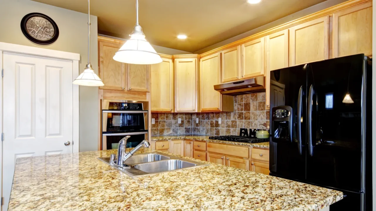 natural wood cabinets in kitchen interior with island and black