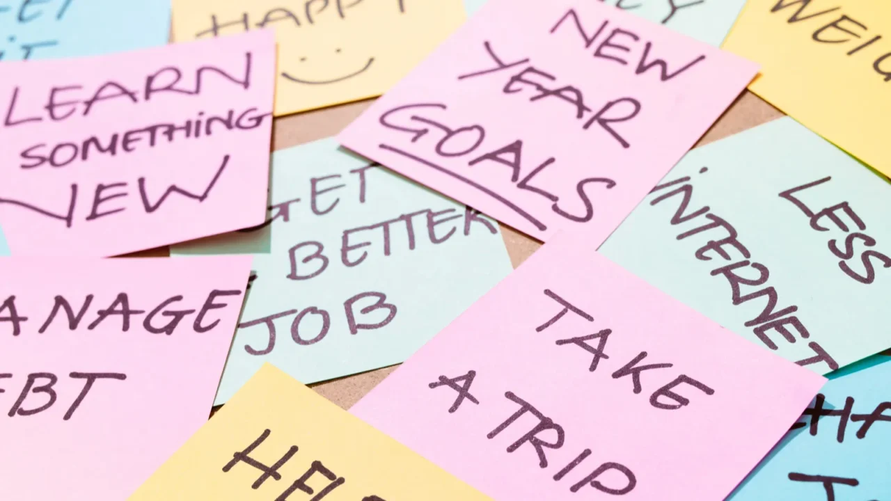 office desk covered by post it papers with different notes