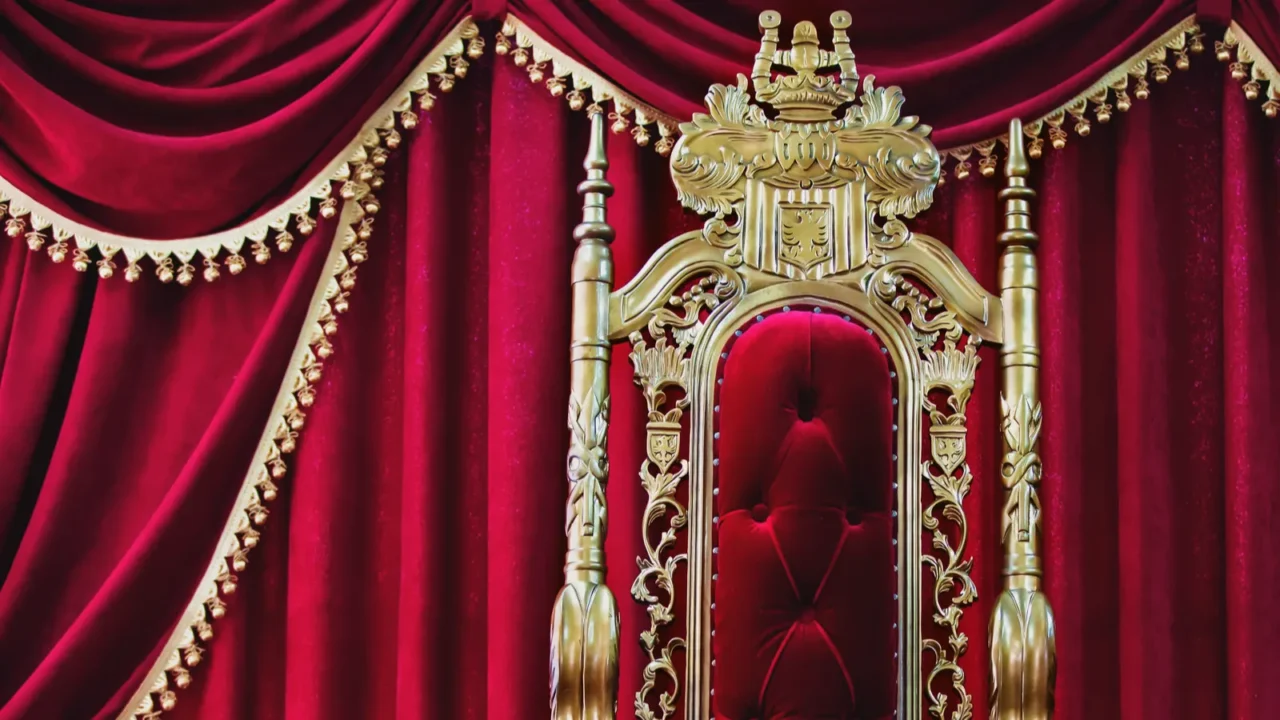 part of the red royal chair against the background of