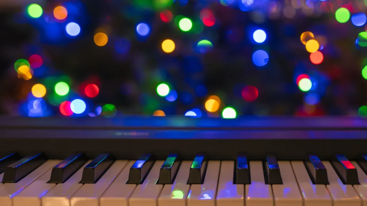 piano keyboard and christmas pine tree illuminations vibrant colors holidays