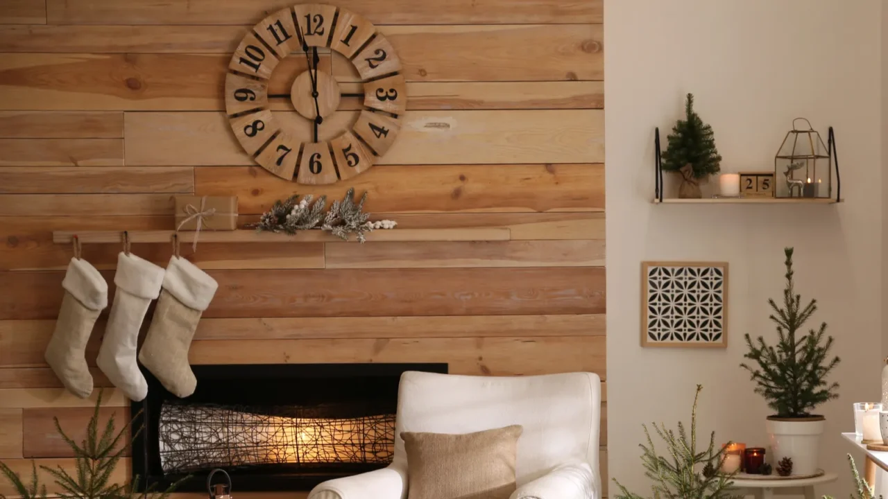 potted fir trees and christmas decorations in room with fireplace