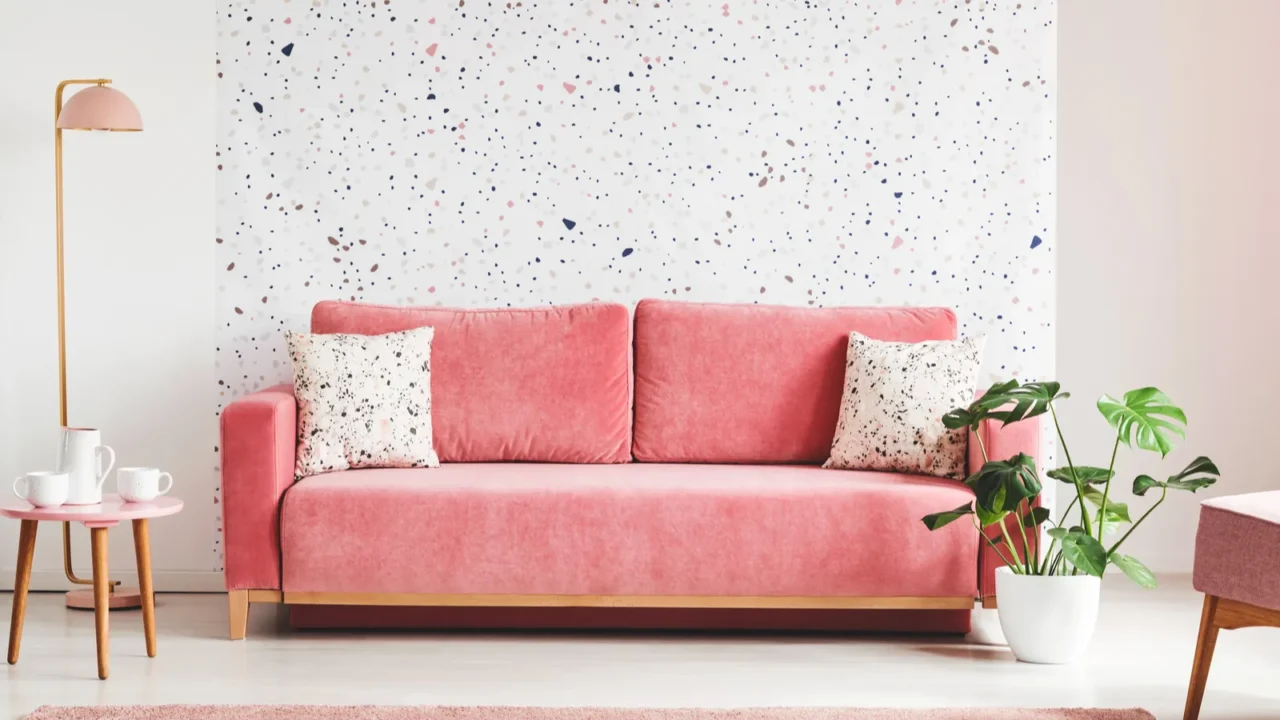 real photo of a pink velvet sofa plant coffee table