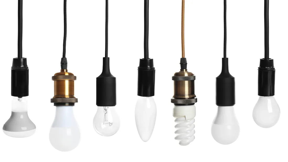 set with different lamp bulbs on white background