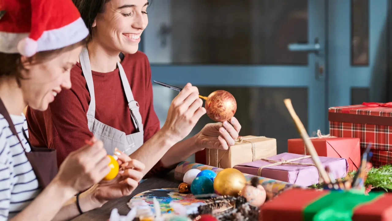 side view portrait of two smiling young women painting