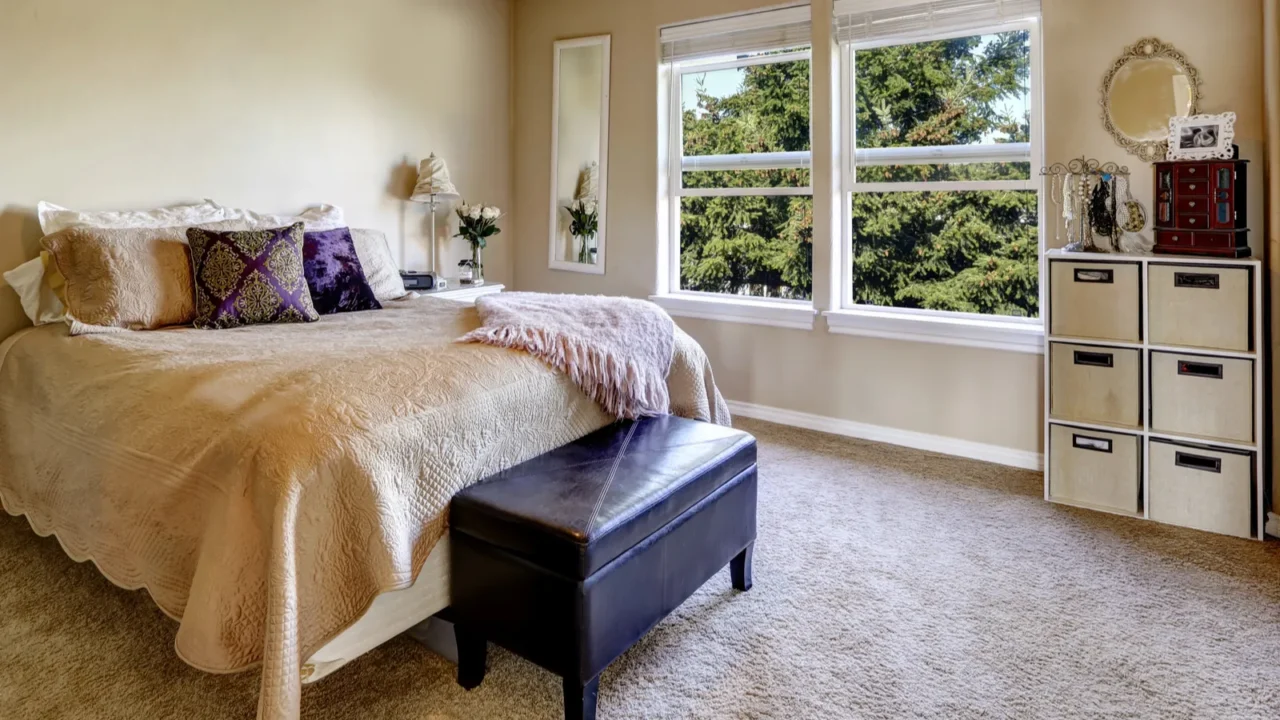 simple bedroom interior with bed and ottoman