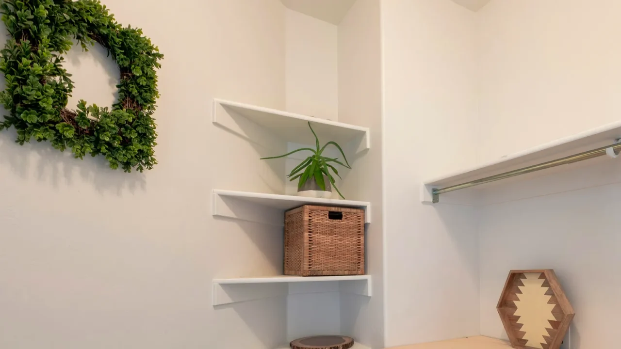 square small minimalist laundry room with wall mounted corner shelves