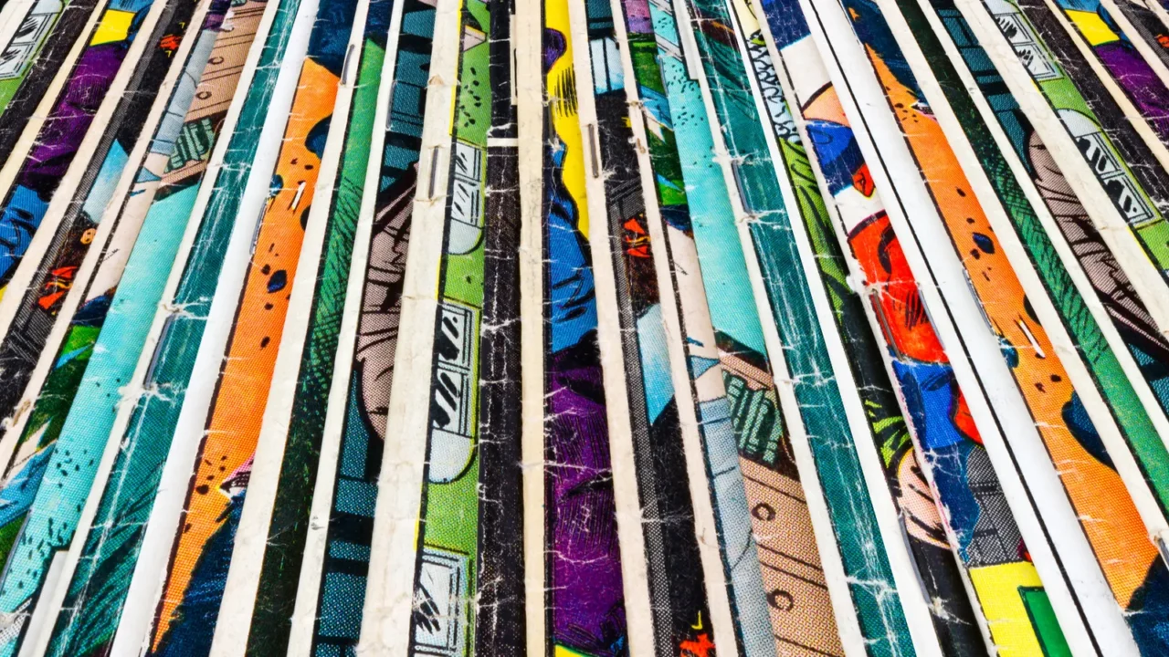 stack of old comic books creates colorful paper background texture