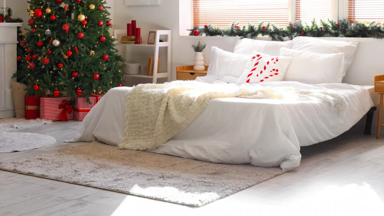 stylish interior of modern light bedroom decorated for christmas