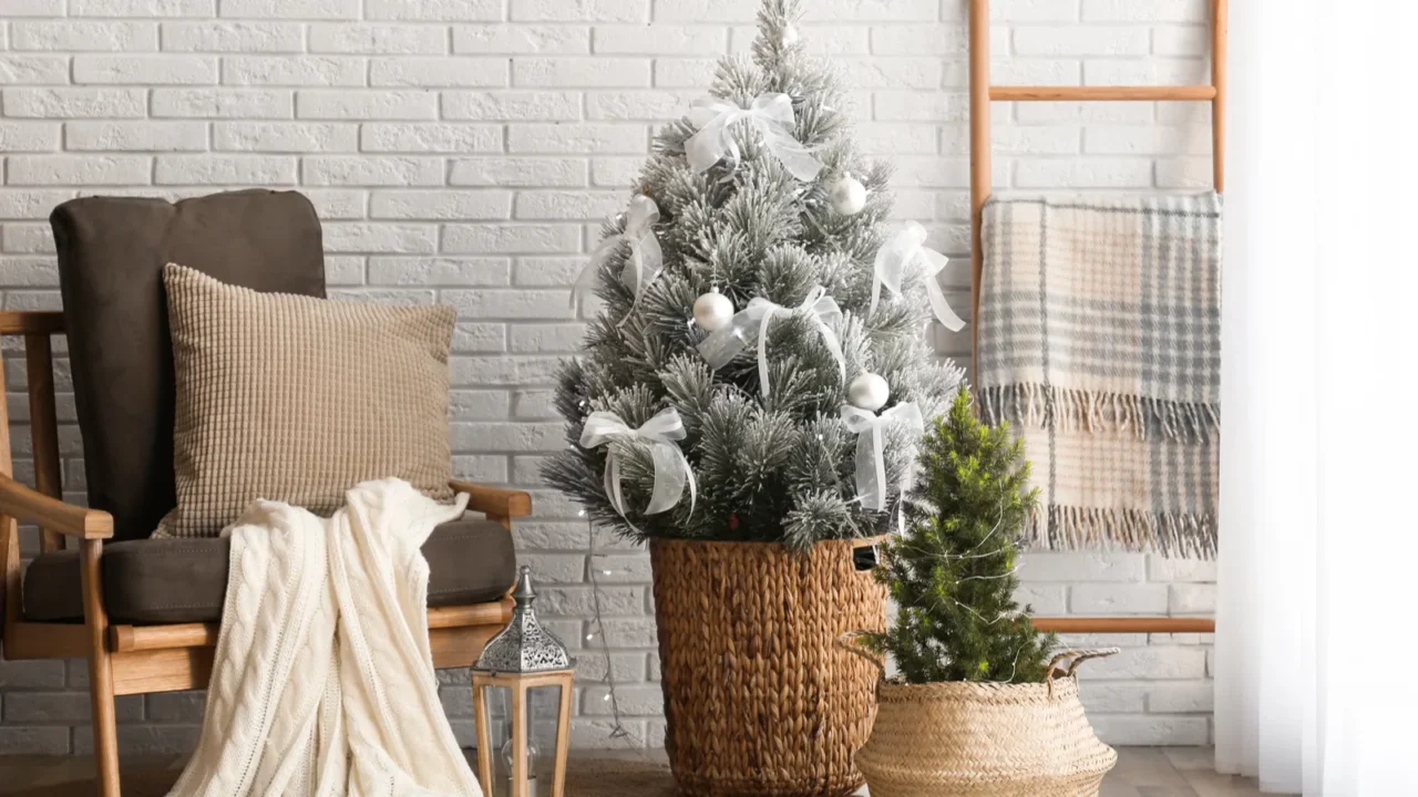 stylish interior with beautiful christmas tree near white brick wall