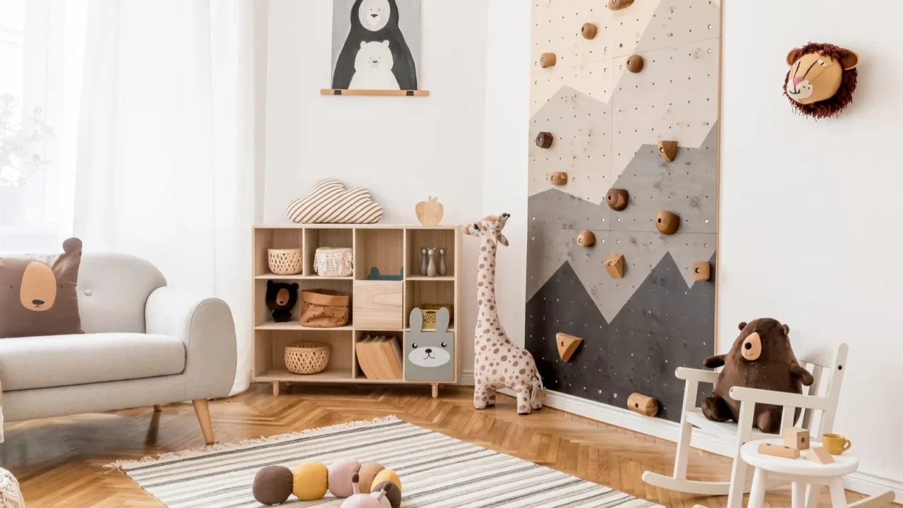 A cozy children's playroom featuring a climbing wall and cheerful animal-themed decor with stylish scandinavian interior design.