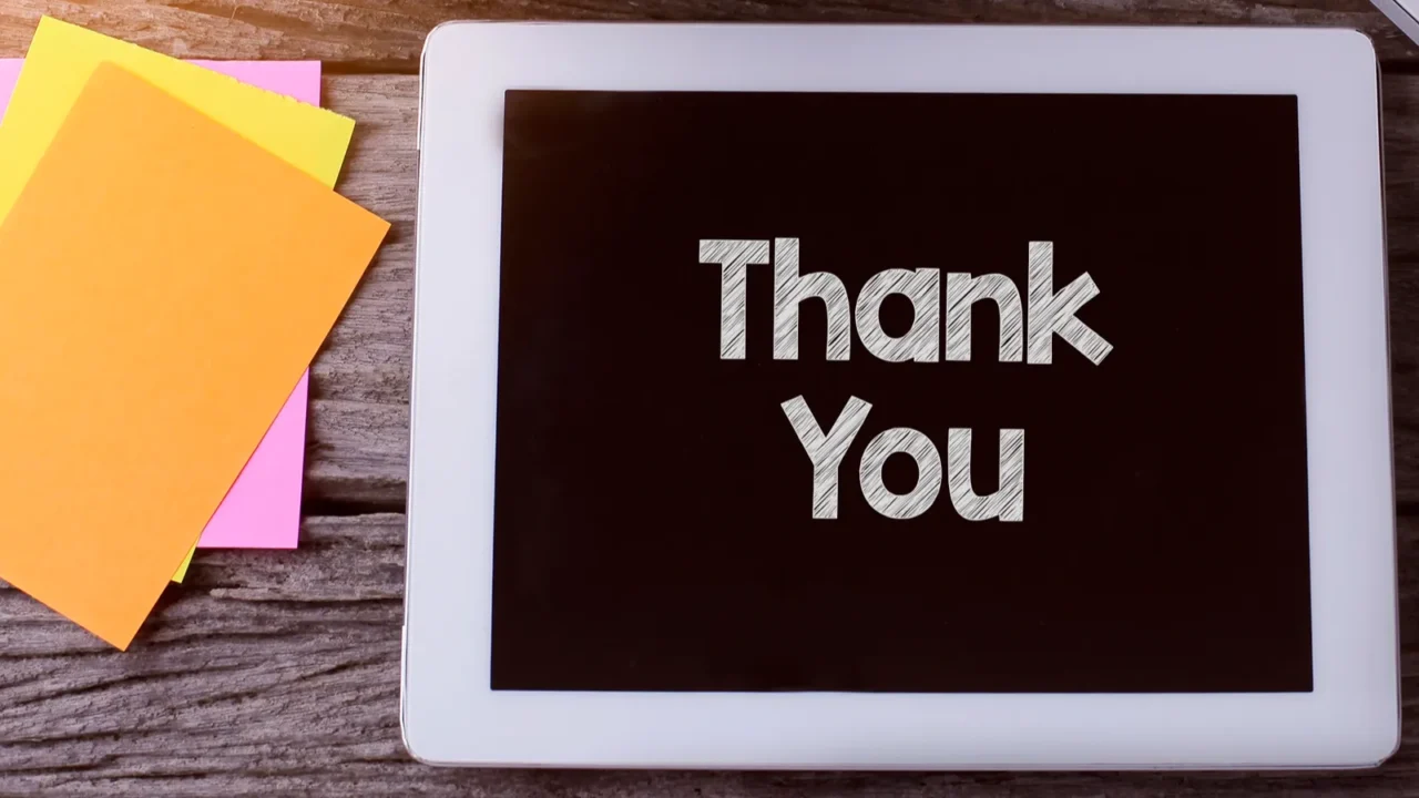 tablet pc with thank you and a cup of coffee