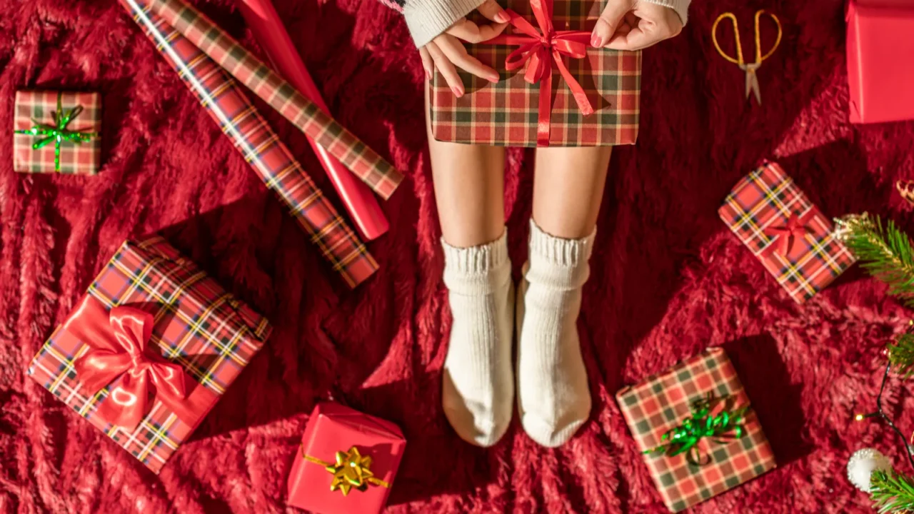 top view of woman with christmas gift box on knees