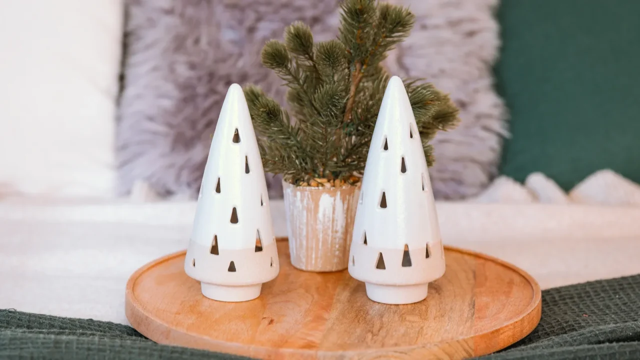 two decorative ceramic trees are positioned on a wooden tray