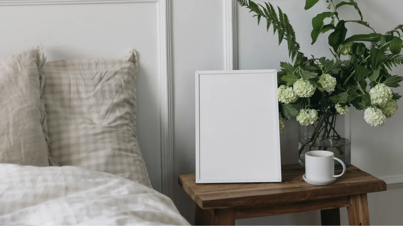 white picture frame mockup and cup of coffee on wooden