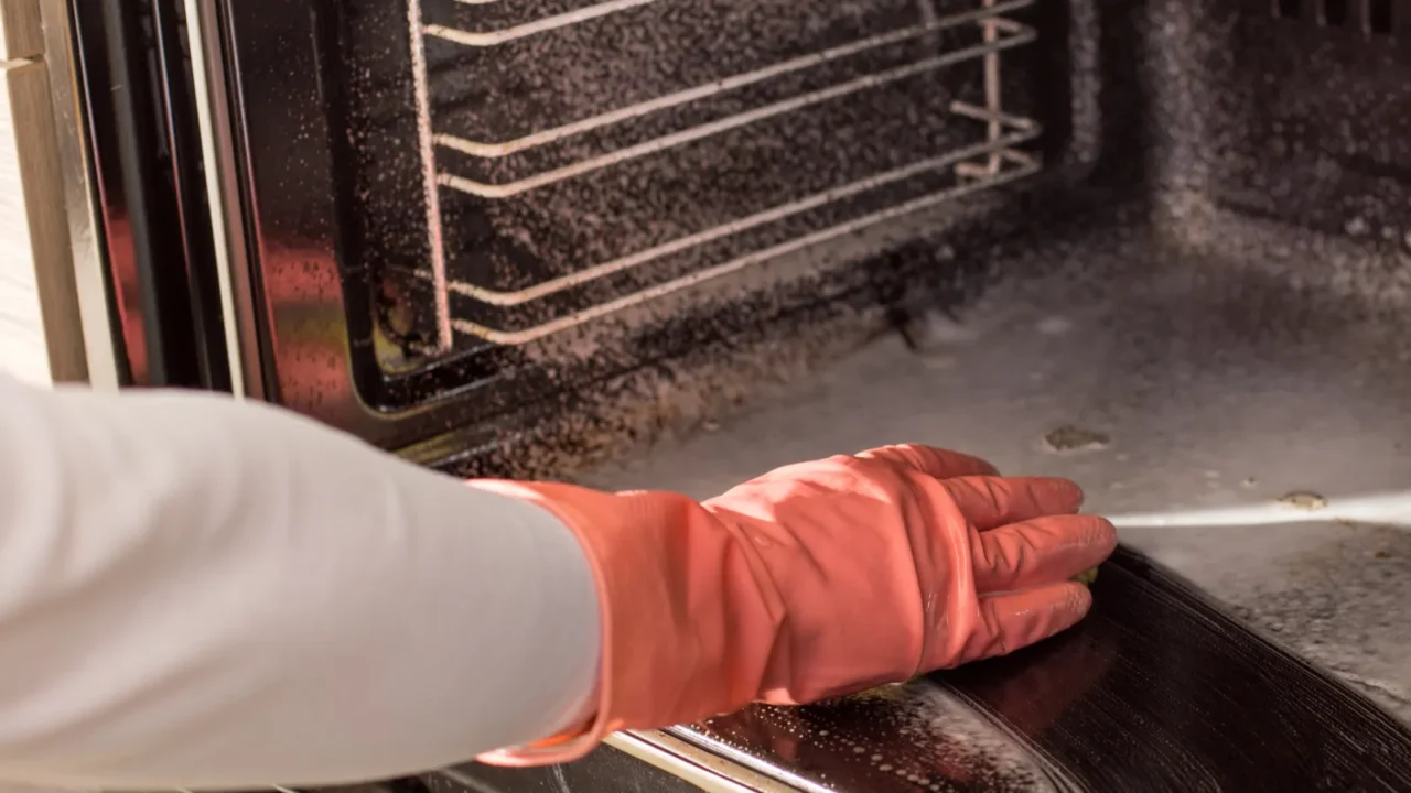 woman cleaning oven